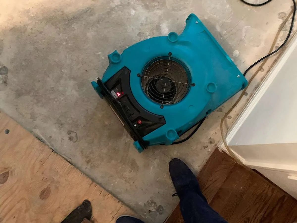 Air mover drying subfloor during Leak Detection & Repair in Dracut
